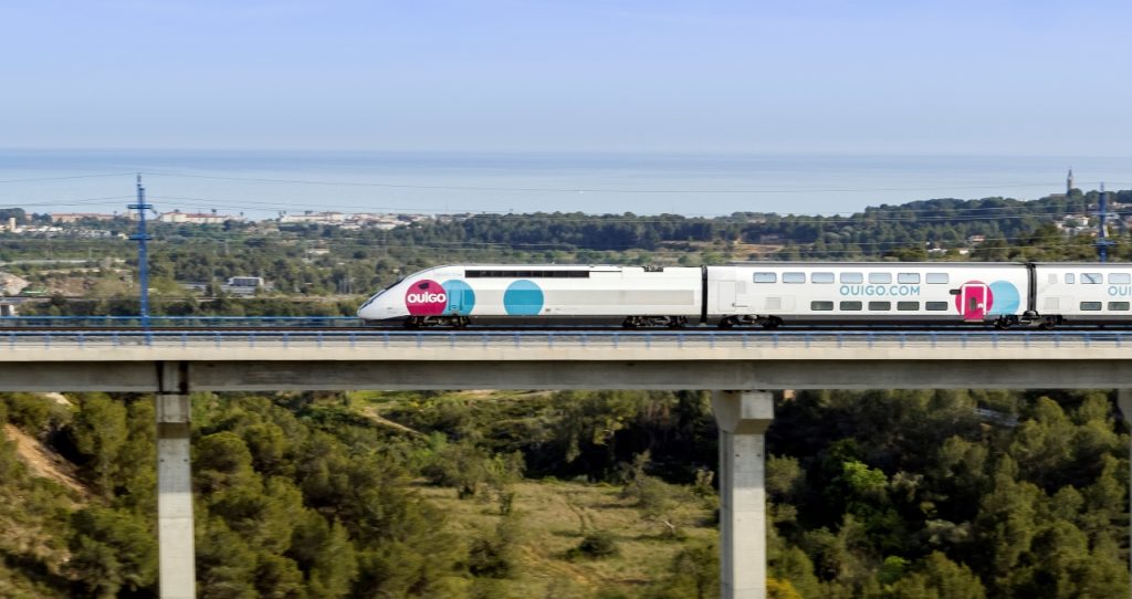 Ouigo train passing on a bridge.