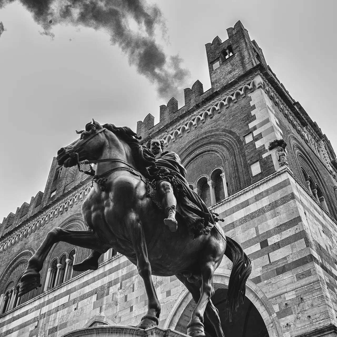 Piacenza's most iconic historical place: piazza Cavalli. The equestrian statue is featured in foreground while the Municipality Palace (Palazzo Gotico) is in the back.